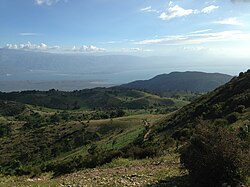 View of border region between the Dominican Republic and Haiti. The border runs horizontally through the middle of the picture.