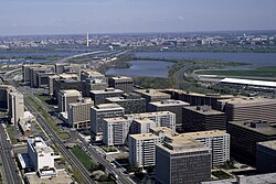 An aerial view of Crystal City with I-395 crossing the Potomac River and the Jefferson Memorial and Washington Monument in the background, 1980s