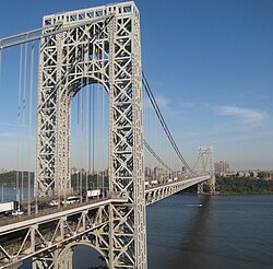 The George Washington Bridge, connecting Fort Lee (foreground) in Bergen County across the Hudson River to New York City (background), is the world's busiest motor vehicle bridge.[252][253]