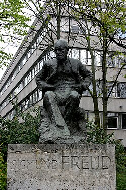 The 1971 Sigmund Freud memorial in Hampstead, North London, by Oscar Nemon, is located near to where Sigmund and Anna Freud lived, now the Freud Museum. The building behind the statue is the Tavistock Clinic, a major psychological health care institution.
