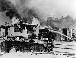 Burning shacks on the Anacostia flats, Washington, D.C., put up by the Bonus Army (World War I veterans) after the marchers with their wives and children were driven out by the regular Army by order of President Hoover, 1932[207]