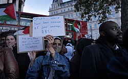 Protester holds sign accusing BBC of biased coverage of the Gaza war.