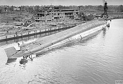 The German cruiser Admiral Scheer capsized in the docks at Kiel after being hit in an RAF raid on the night of 9/10 April 1945.