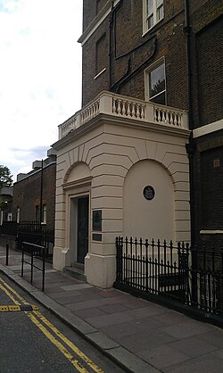 The Faber & Faber building where Eliot worked from 1925 to 1965; the commemorative plaque is under the right-hand arch.