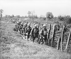 Men of the Irish Guards going up a communication trench at Elverdinghe, 30 July 1917.