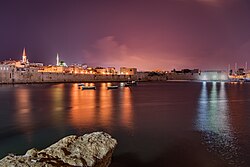 Acre's sea wall at night.