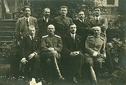 The first government ("activists") of the Belarusian People's Republic (BNR, Беларуская Народная Рэспубліка), 1918.Sitting, left to right:Aliaksandar Burbis, Jan Sierada, Jazep Varonka, Vasil Zacharka.Standing, left to right:Arkadź Smolič, Pyotra Krecheuski, Kastuś Jezavitaŭ, Anton Ausianik, Liavon Zayats.
