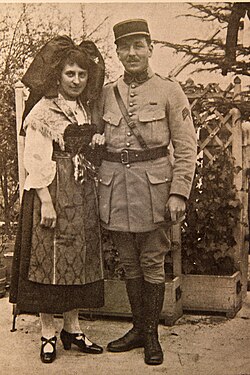 An Alsatian woman in traditional dress and a French officer, c. 1919