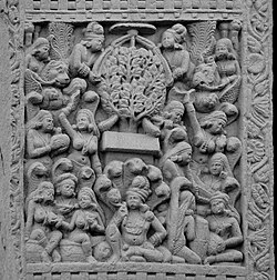 An aniconic depiction of the Buddha's spiritual liberation (moksha) or awakening (bodhi), at Sanchi. The Buddha is not depicted, only symbolised by the Bodhi tree and the empty seat