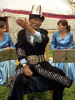 A Kyrgyz manaschi performing part of the Epic of Manas at a yurt camp in Karakol