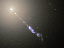 Figure 5–6. Galaxy M87 sends out a black-hole-powered jet of electrons and other sub-atomic particles traveling at nearly the speed of light.