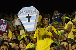 Brazilian fan with a fake coffin with the colors of the Argentine flag and the name "Maradona" in 2009
