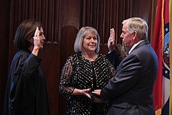 Parson being sworn in as Governor of Missouri in 2018 by Mary Rhodes Russell alongside his wife Teresa