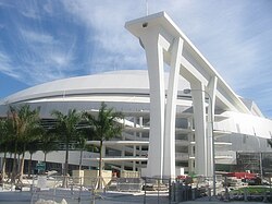 An LED show illuminates the super columns during night games, and a rubber membrane lining the roof reduces heat-island effect.