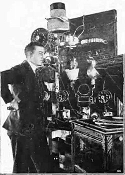 Lee de Forest used an early vacuum-tube transmitter to broadcast returns for the Hughes-Wilson presidential election returns on November 7, 1916, over 2XG in New York City. Pictured is engineer Charles Logwood.[4]