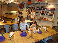 At the Buell Children's Museum in Pueblo, Colorado, children and their guardians partake in "arts and crafts" (i.e. handicrafts)