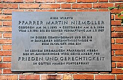 Plaque commemorating the second Reich's Synod of Confession on the outside wall of the fellowship hall