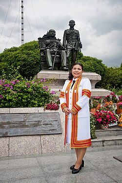 A doctoral graduate (Ph.D.) of Chulalongkorn University in Thailand, dressed in an academic gown for her graduation ceremony