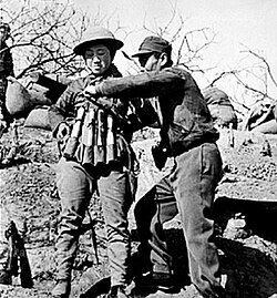 Chinese suicide bomber putting on a 24 hand grenade-explosive vest prior to attack on Japanese tanks at the Battle of Taierzhuang.
