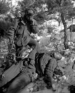 5th Regimental Combat Team soldier with a dead PVA soldier
