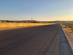 M10 Motorway near Urum Al-Jouz village. Ariha - Latakia motorway is constructed by Kwaiti Al-Kharafi construction company. The motorway has four to six lanes in total divided by tall cast Jersey barrier.