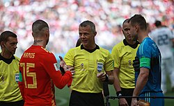 Ramos (left, in red) with Russia captain Igor Akinfeev (right, in blue) and referee Björn Kuipers before the 2018 World Cup Round of 16 match at the Luzhniki Stadium in Moscow.
