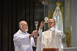Holy Mass at the Sanctuary of Our Lady of Fátima, Portugal. The host and the chalice are displayed to the people immediately after the consecration of the bread and wine into the Holy Body and Blood of Christ.