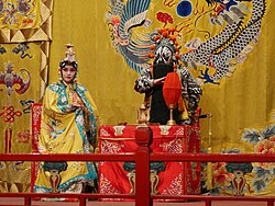 Two Peking Opera actors performing on stage in ornate costumes