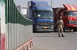 An Iranian border guard supervising trucks entering "Shalamsha Port of Entry" in Iran–Iraq border