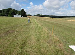 The grass airstrip on the Badminton estate, Badminton, South Gloucestershire, England. The strip is very simple: no lighting, no centerline, and no approach aids. The edge is marked by simple posts.