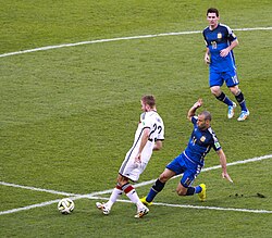 Mascherano going in for a tackle against Germany's Christoph Kramer in the 2014 FIFA World Cup final