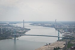 The Detroit-Windsor border crossing is the busiest international border crossing in North America by trade volume, with approximately one-third of all Canada–U.S. trade passing through this link. Pictured in the background is the under-construction Gordie Howe International Bridge, which will complement the existing Ambassador Bridge, shown in the foreground.