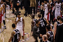 Toronto-based hip-hop musician Drake stands courtside during the first round of the 2014 playoffs. Drake was named the "global ambassador" for the Raptors in September 2013.